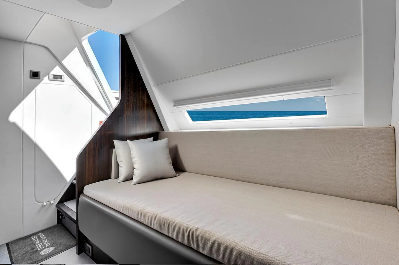 A cozy cabin with a comfortable bed and a window offering a view of the sea. aboard MISTY K Yacht for Sale