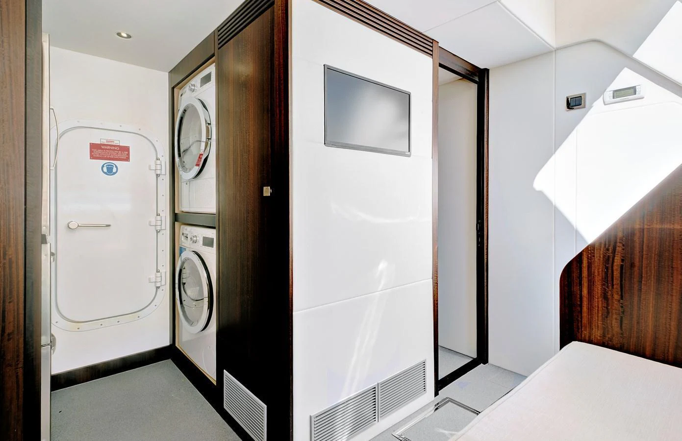 The yacht's interior features a practical laundry area with modern appliances and sleek design. aboard MISTY K Yacht for Sale