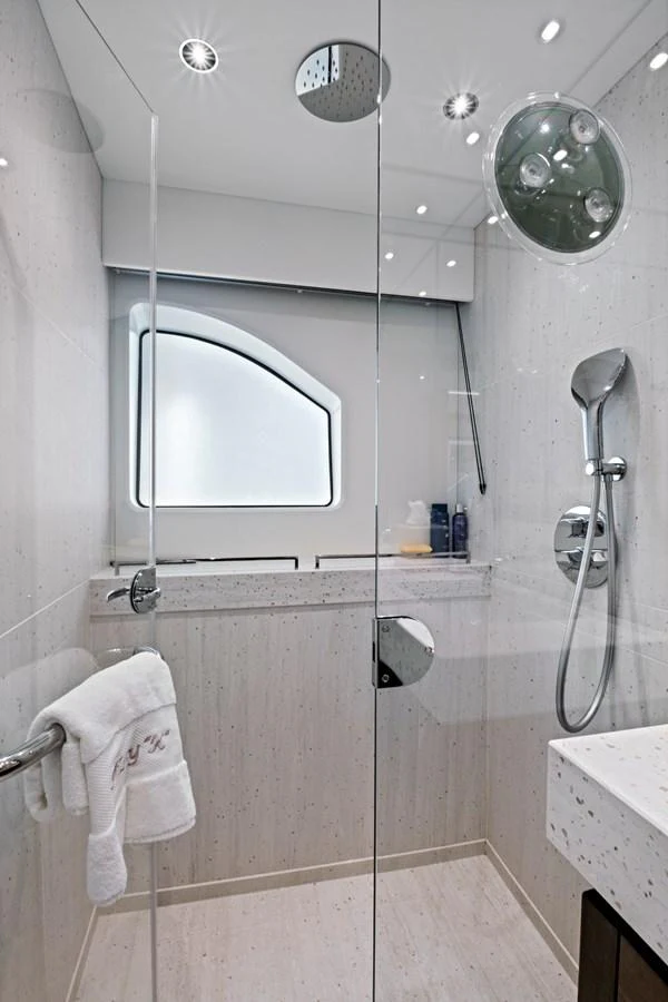 The yacht's bathroom features a sleek, modern design with a glass-enclosed shower and elegant fixtures. aboard MISTY K Yacht for Sale