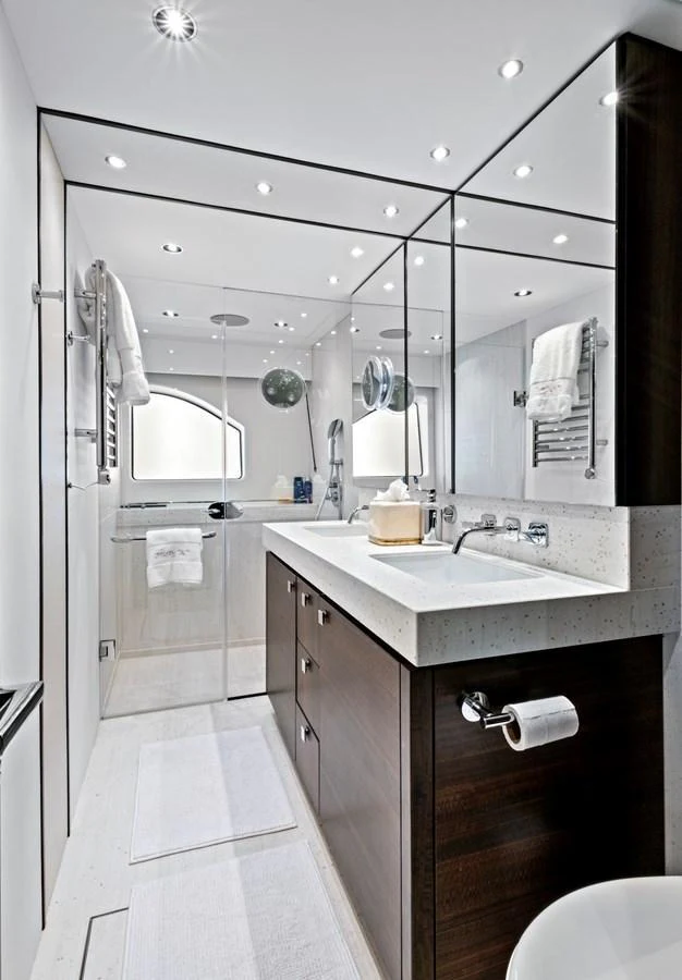 A sleek and modern yacht bathroom with elegant fixtures and ample lighting. aboard MISTY K Yacht for Sale