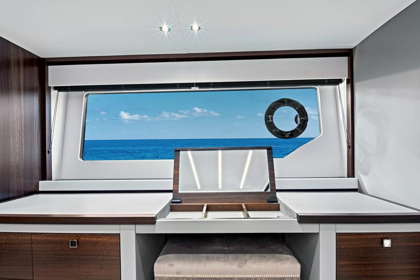 A modern yacht interior with a large window offering a stunning ocean view. aboard MISTY K Yacht for Sale