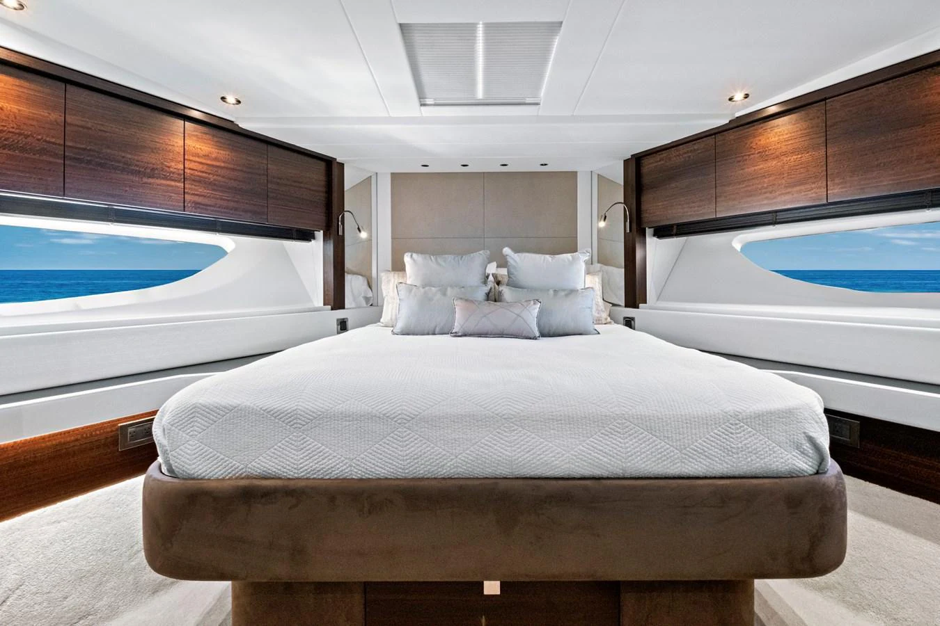 The master stateroom features a luxurious bed with panoramic ocean views through large windows. aboard MISTY K Yacht for Sale