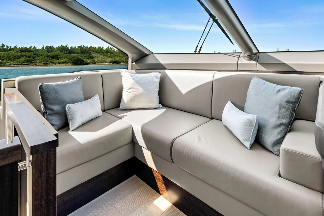 The salon features a comfortable L-shaped seating area with plush cushions and ample natural light. aboard MISTY K Yacht for Sale