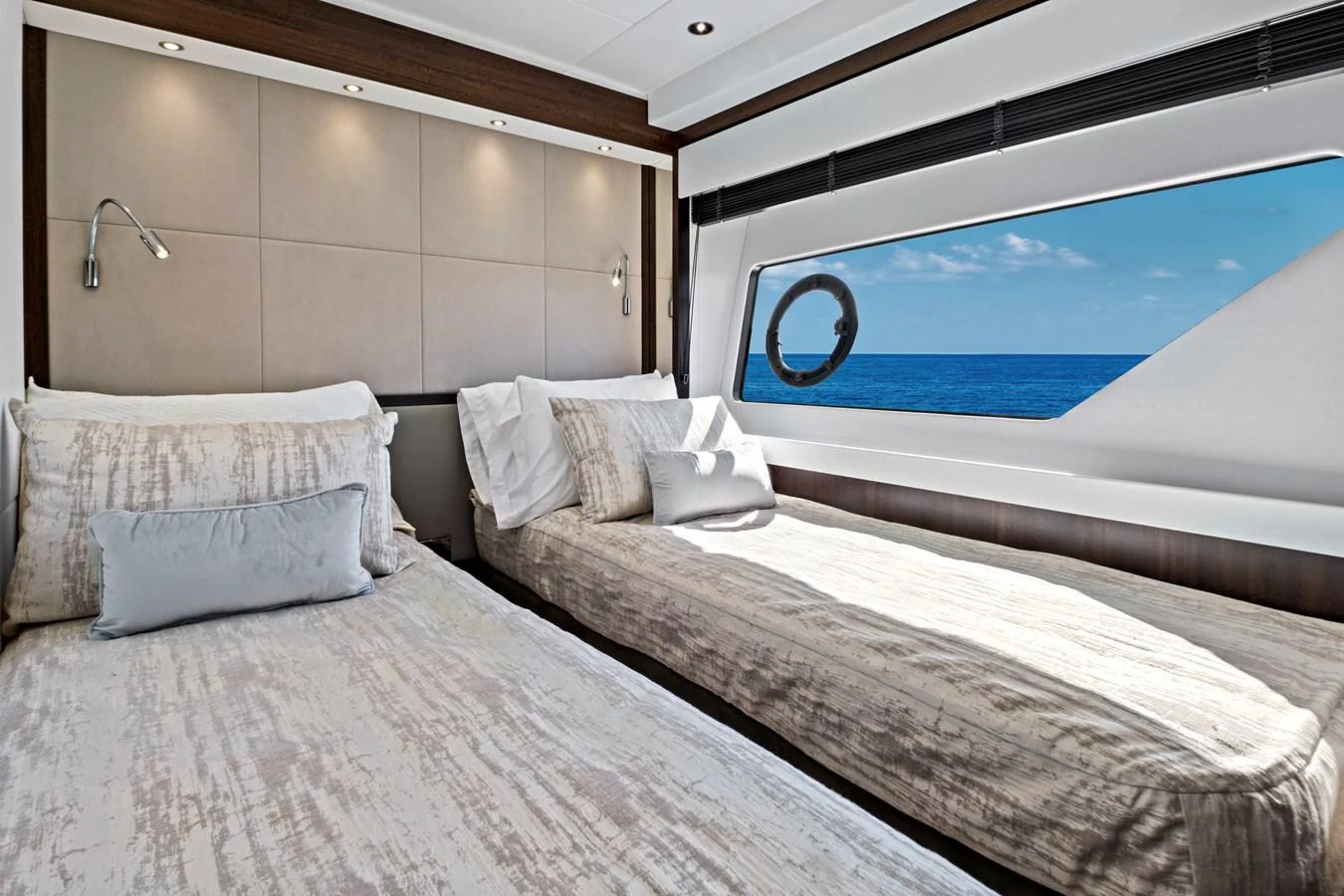The guest stateroom features twin beds with a large window offering a stunning ocean view. aboard MISTY K Yacht for Sale