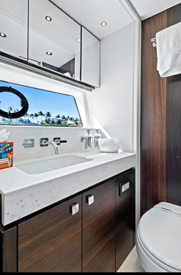 A sleek and modern yacht bathroom with a window offering a scenic view. aboard MISTY K Yacht for Sale