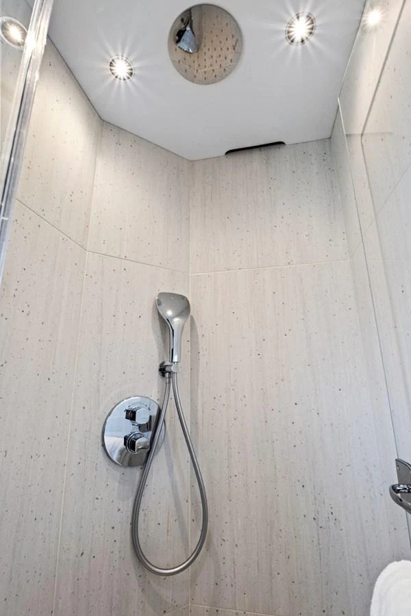 A modern yacht shower with sleek fixtures and elegant lighting. aboard MISTY K Yacht for Sale
