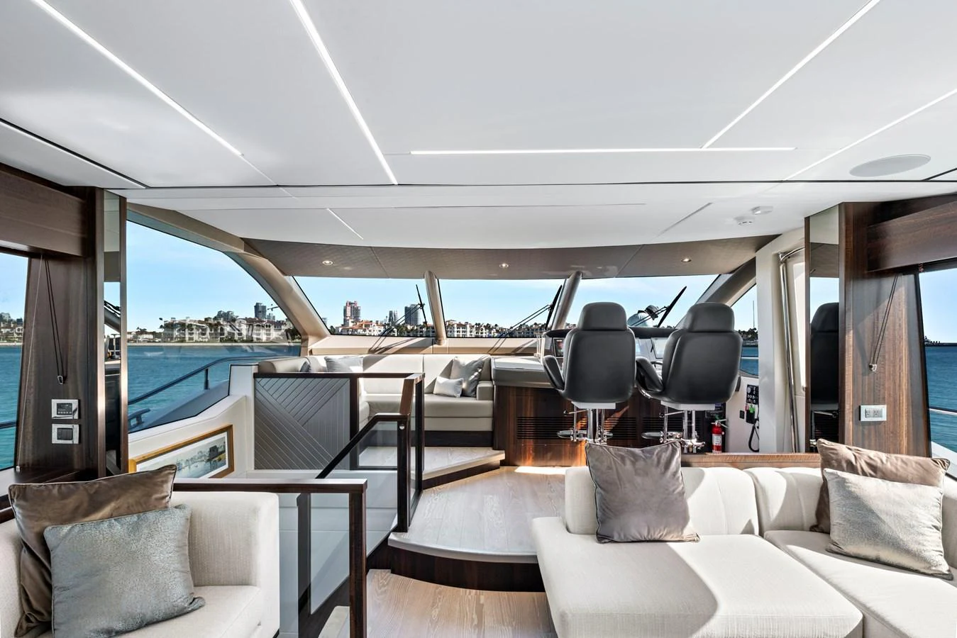 The yacht's salon features modern furnishings and expansive windows offering stunning views. aboard MISTY K Yacht for Sale