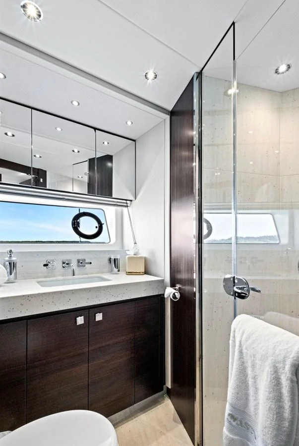 A modern yacht bathroom featuring sleek fixtures and ample lighting. aboard MISTY K Yacht for Sale