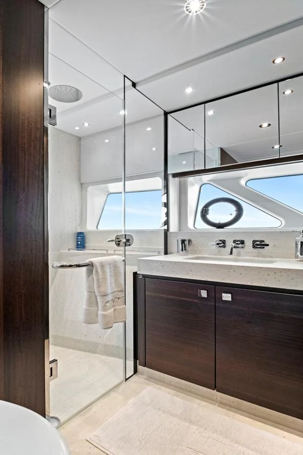 A modern and sleek yacht bathroom with a glass shower and elegant fixtures. aboard MISTY K Yacht for Sale