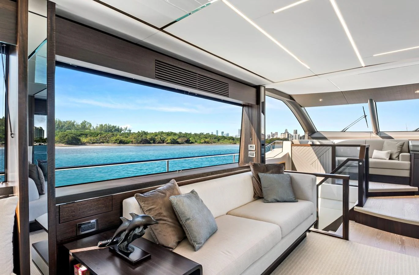 The yacht's salon features modern furnishings with large windows offering stunning water views. aboard MISTY K Yacht for Sale