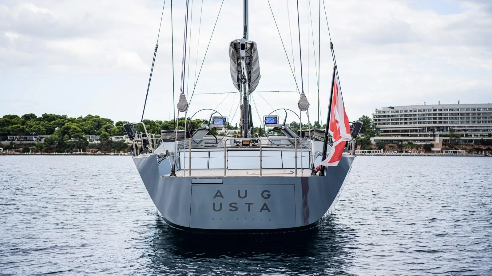 A sleek yacht is anchored in calm waters, showcasing its modern design and elegant lines. aboard AUGUSTA WALLY Yacht for Sale
