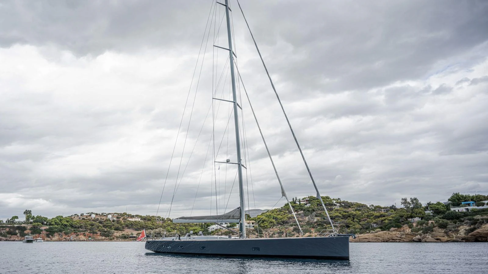 A sleek sailing yacht glides gracefully on calm waters under a cloudy sky. aboard AUGUSTA WALLY Yacht for Sale