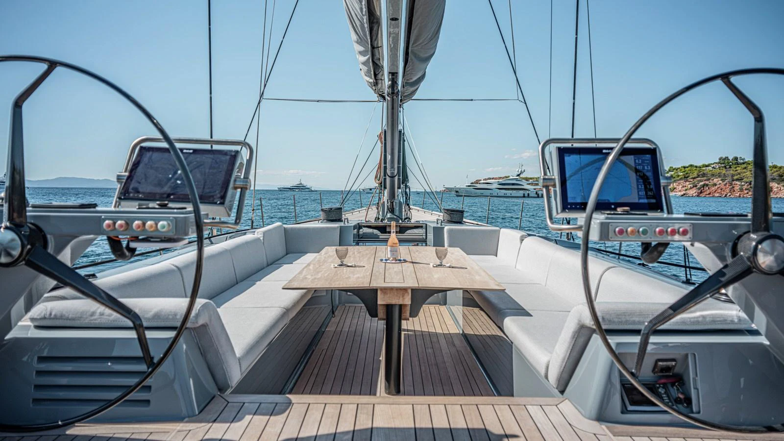 The yacht's cockpit features dual helm stations and a spacious seating area with a central table, perfect for outdoor dining and navigation. aboard AUGUSTA WALLY Yacht for Sale