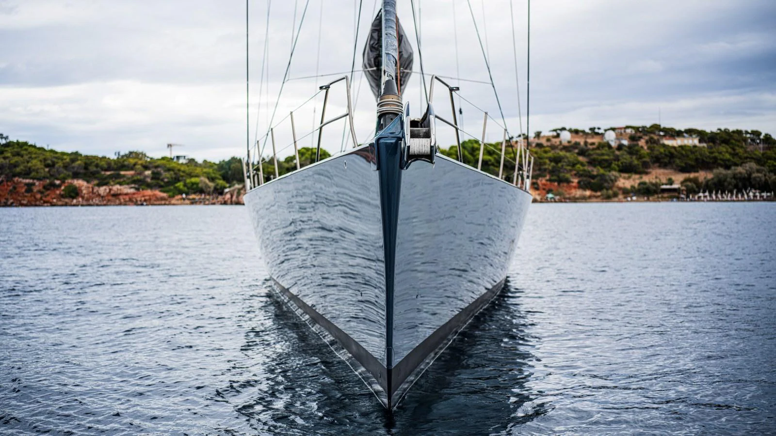 The yacht is captured head-on, showcasing its sleek and modern design on calm waters. aboard AUGUSTA WALLY Yacht for Sale