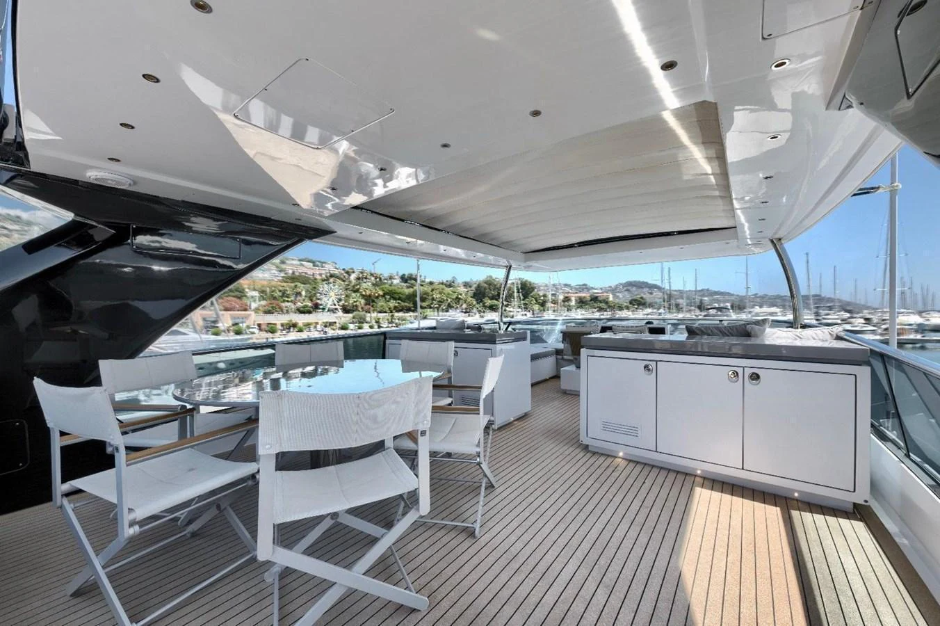 The aft deck offers a spacious and stylish outdoor dining area with a view of the marina. aboard MARIPOSA Yacht for Sale