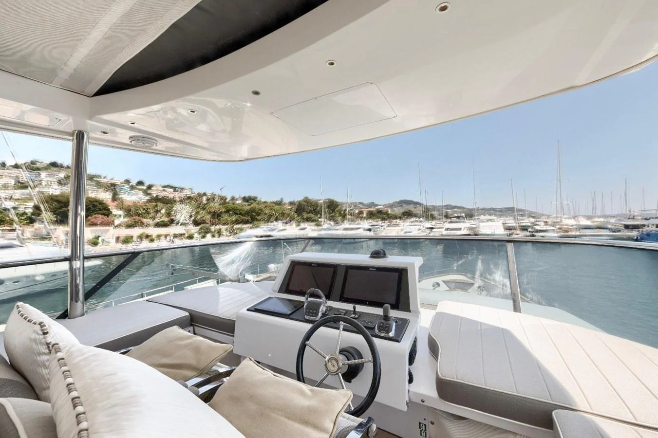 The helm station offers a panoramic view of the marina, blending comfort with advanced navigation technology. aboard MARIPOSA Yacht for Sale