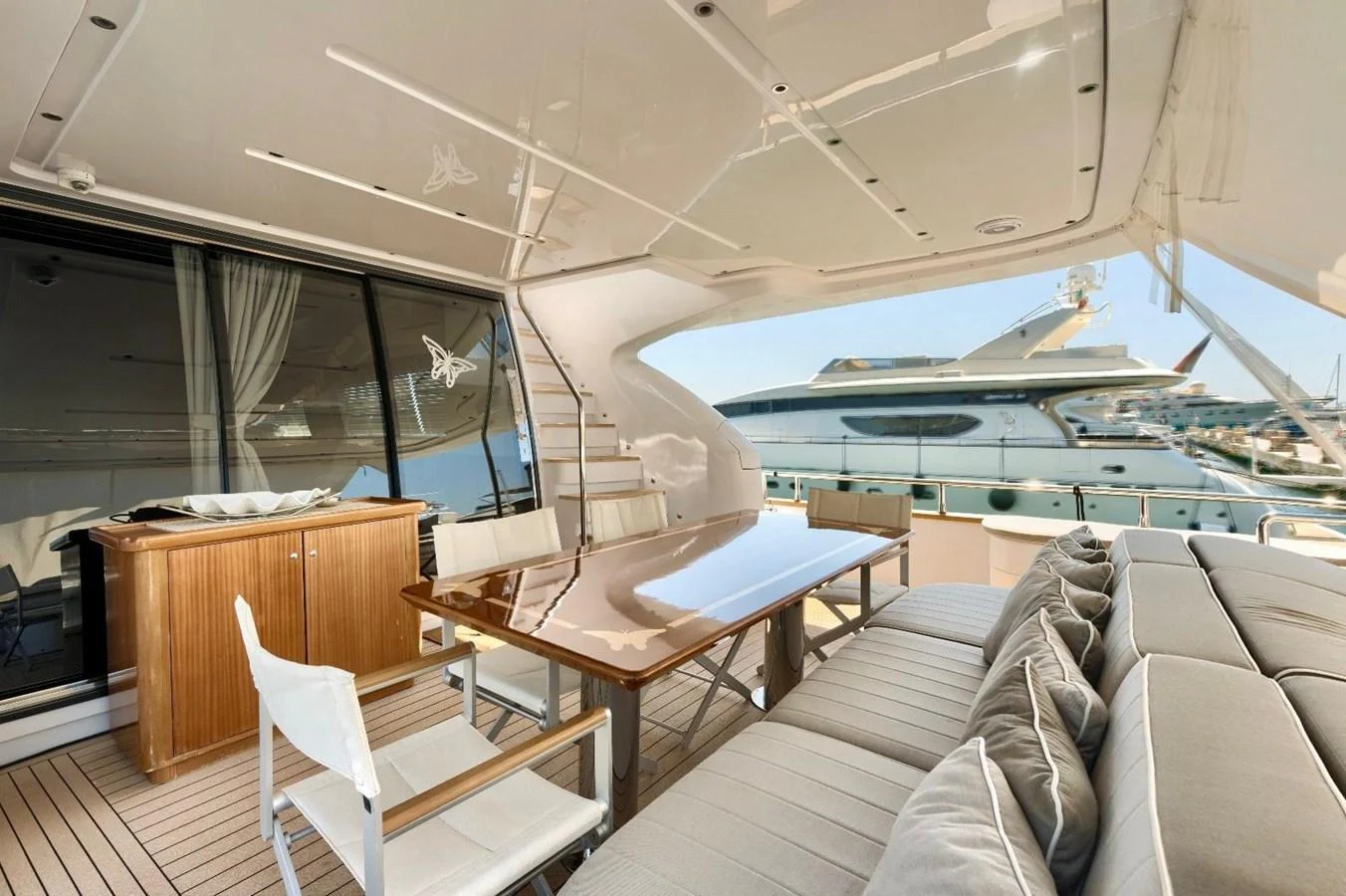 The aft deck features a stylish dining area with a polished table and comfortable seating, perfect for alfresco meals. aboard MARIPOSA Yacht for Sale