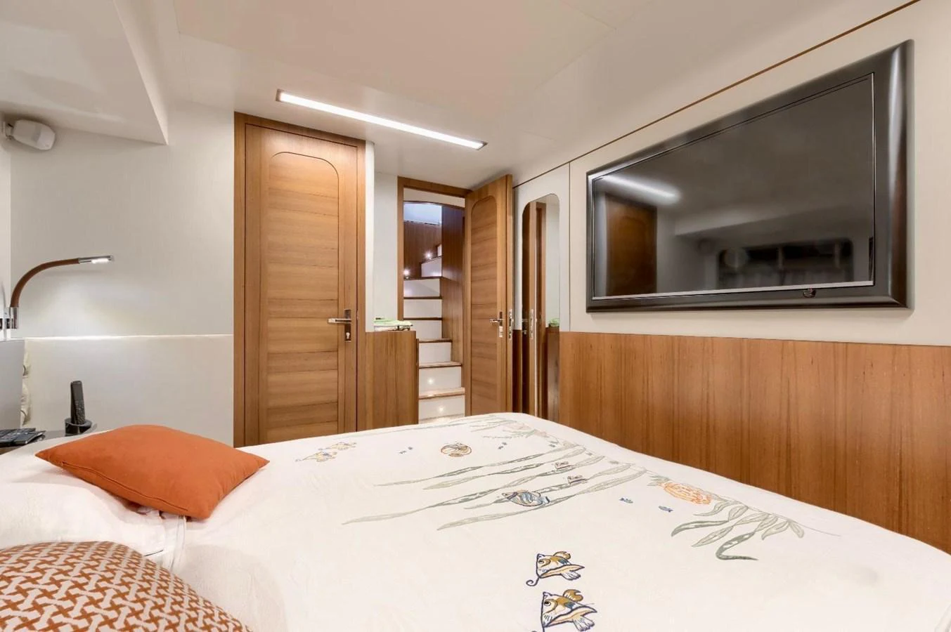 The stateroom features a comfortable bed with elegant linens and a large flat-screen TV. aboard MARIPOSA Yacht for Sale