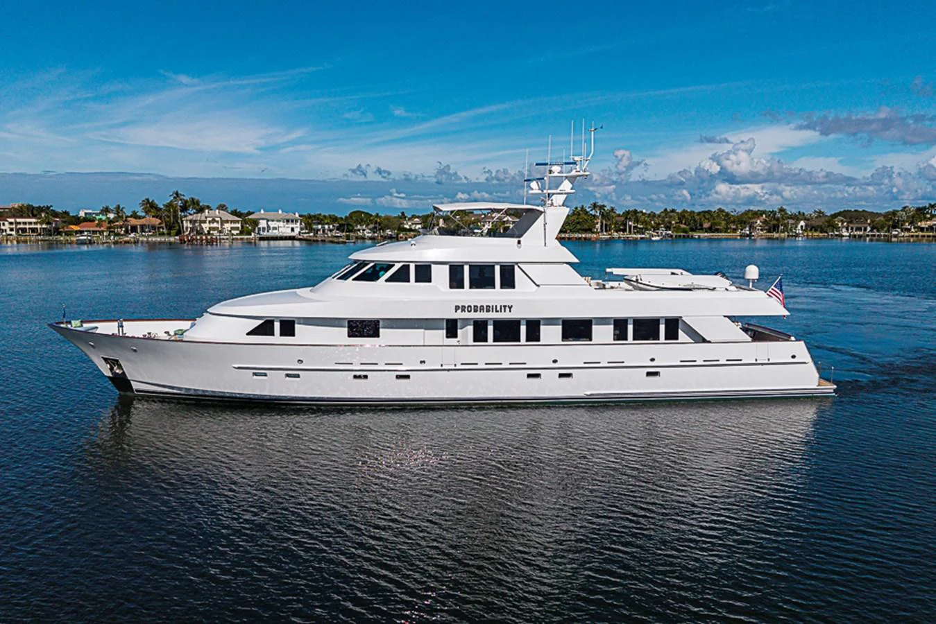 A sleek and elegant yacht glides gracefully on calm waters, showcasing its pristine exterior design. aboard PROBABILITY Yacht for Sale