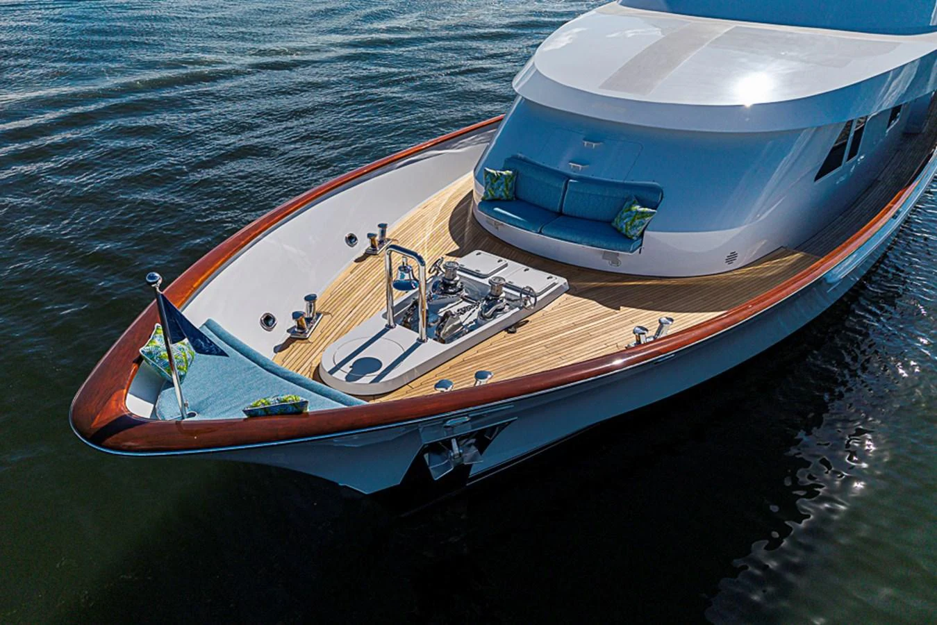 The yacht's foredeck features a spacious lounging area with plush cushions and a sleek design. aboard PROBABILITY Yacht for Sale