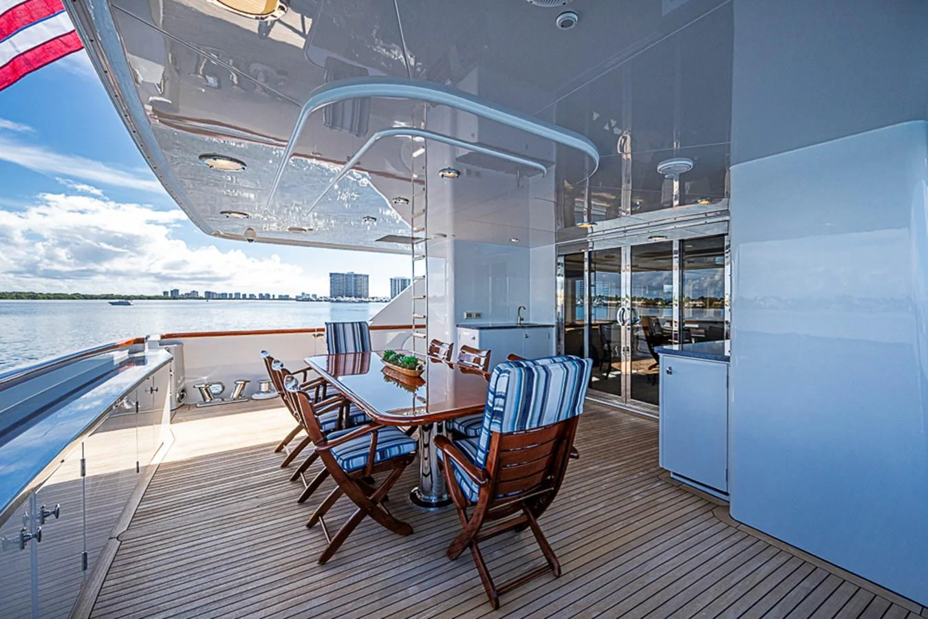 The aft deck offers a spacious and inviting area for alfresco dining with a stunning view of the water. aboard PROBABILITY Yacht for Sale