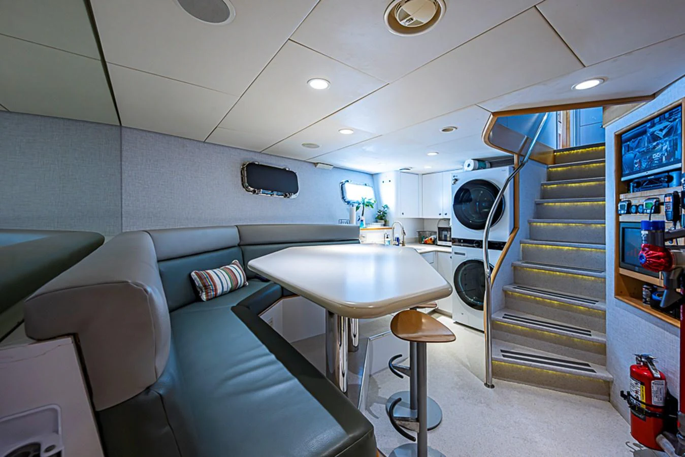 The galley area features a cozy dining nook, modern appliances, and convenient access to the upper deck. aboard PROBABILITY Yacht for Sale