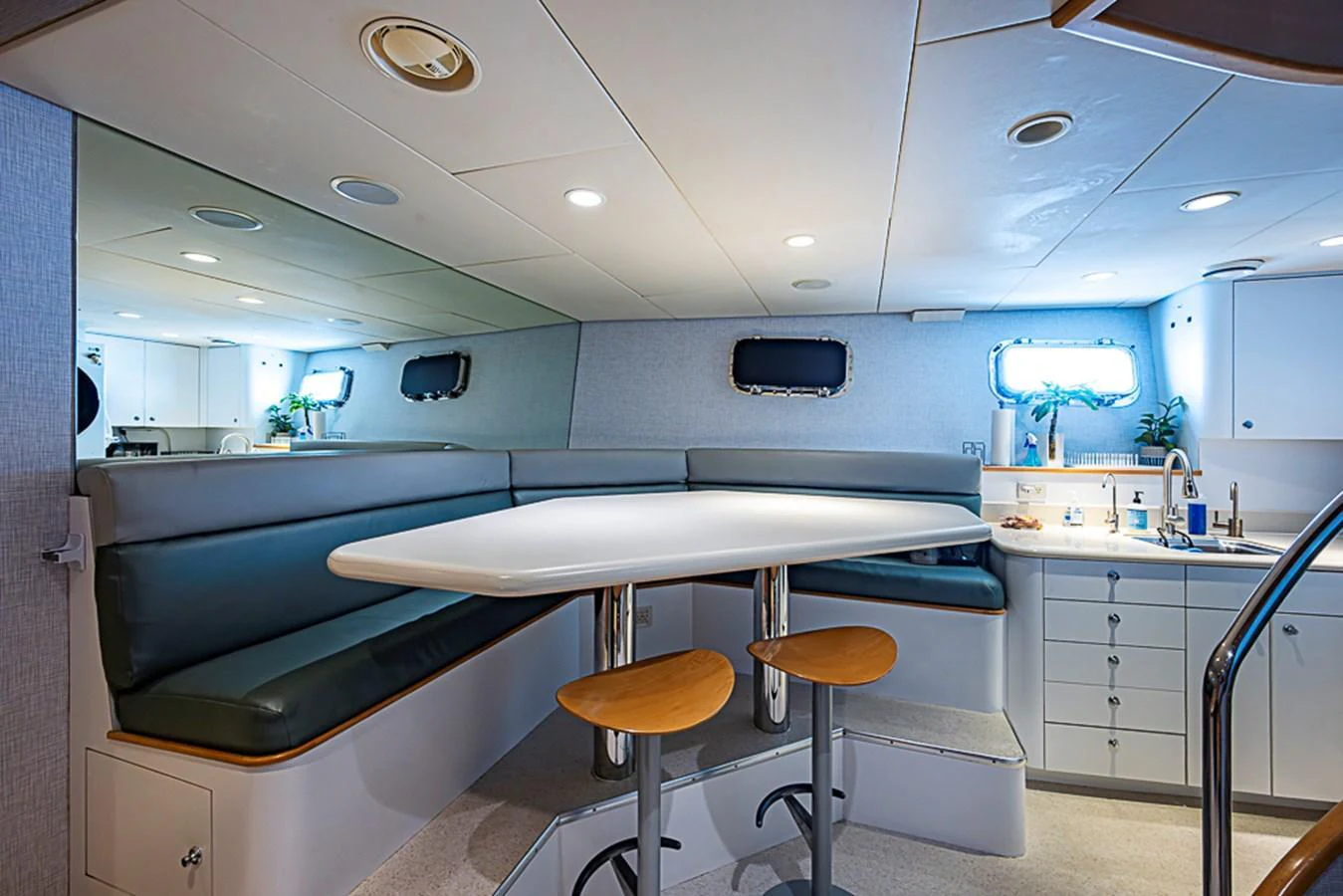 The yacht's galley features a cozy dining area with a modern table and comfortable seating. aboard PROBABILITY Yacht for Sale
