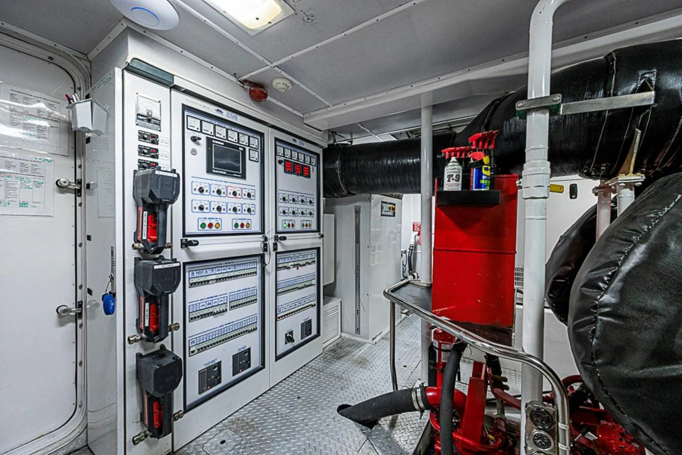 The yacht's engine room showcases advanced control panels and essential machinery. aboard PROBABILITY Yacht for Sale