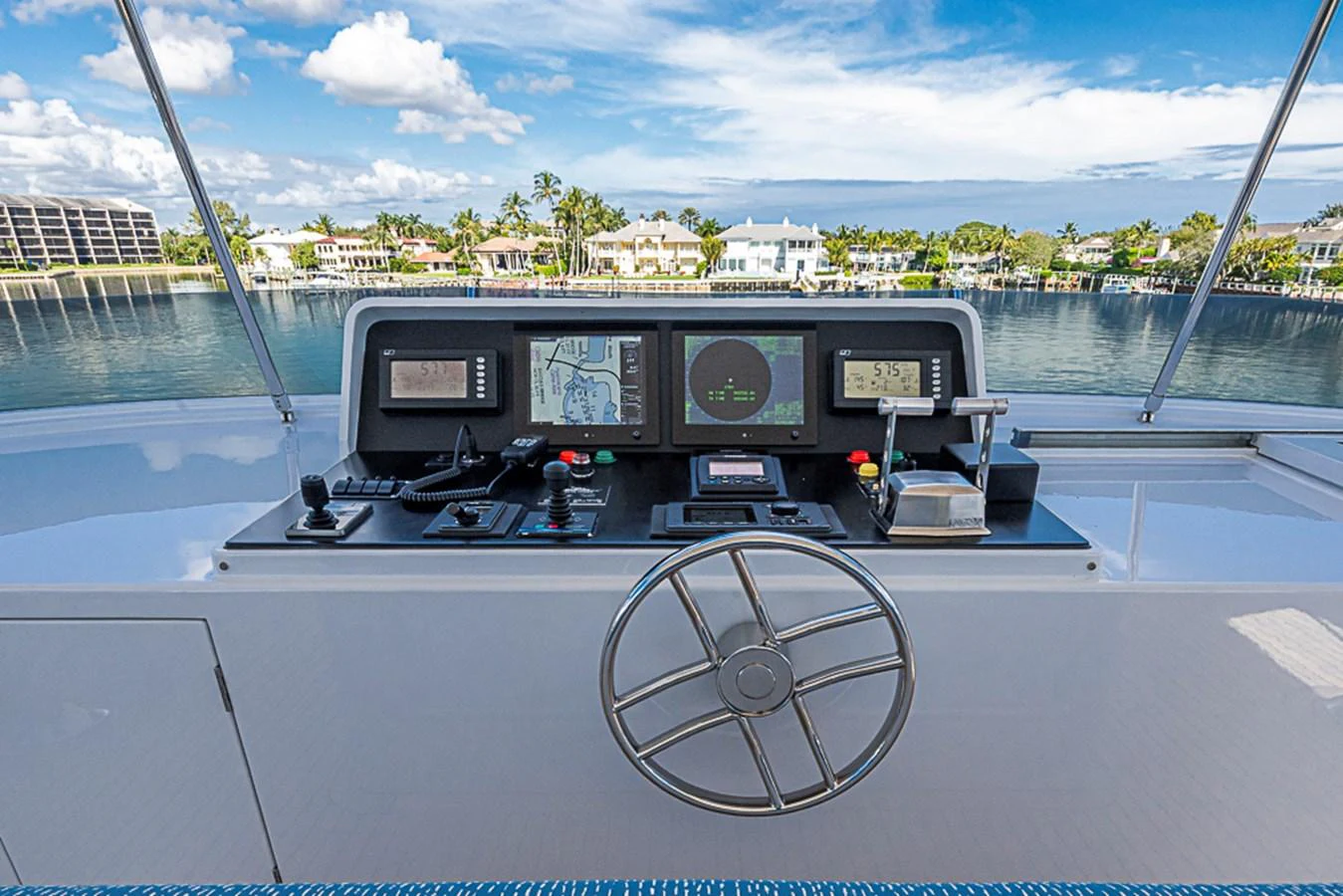 The helm station offers a commanding view with advanced navigation equipment and a sleek steering wheel. aboard PROBABILITY Yacht for Sale