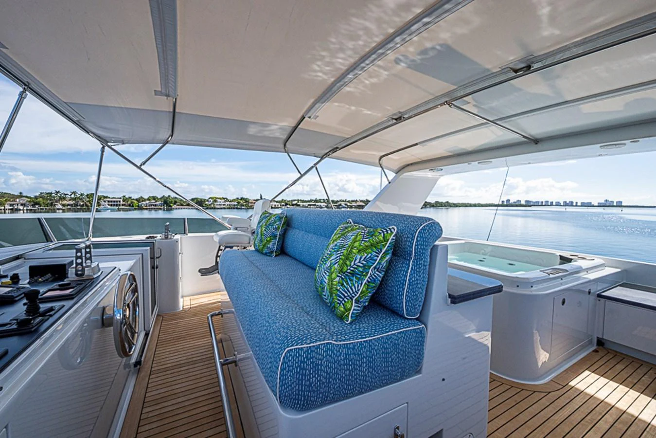 The flybridge offers a spacious seating area with vibrant cushions and a stunning view of the water. aboard PROBABILITY Yacht for Sale