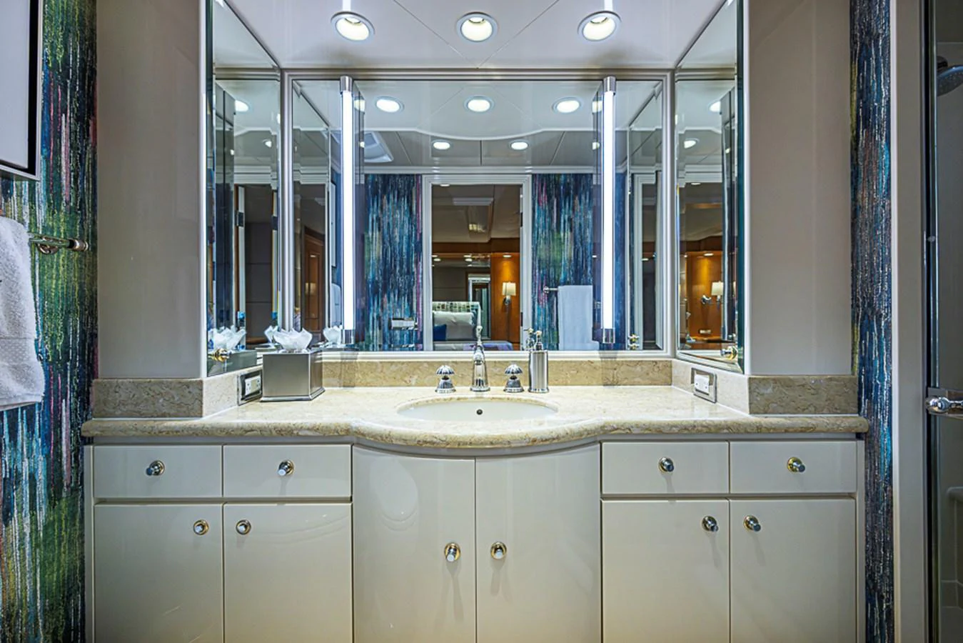 The yacht's bathroom features a luxurious vanity with ample lighting and elegant fixtures. aboard PROBABILITY Yacht for Sale