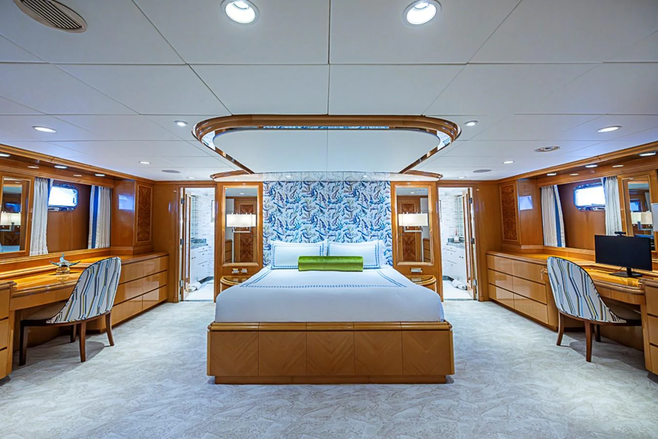 The master stateroom features a spacious bed, elegant wood finishes, and ample natural light. aboard PROBABILITY Yacht for Sale