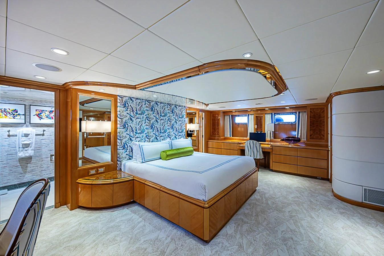 The master stateroom features a luxurious bed, elegant wood finishes, and a spacious layout. aboard PROBABILITY Yacht for Sale
