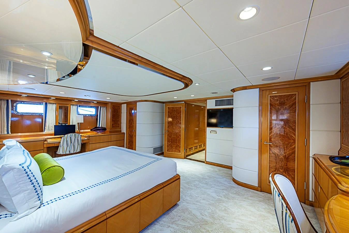 A luxurious stateroom featuring a comfortable bed and elegant wood finishes. aboard PROBABILITY Yacht for Sale