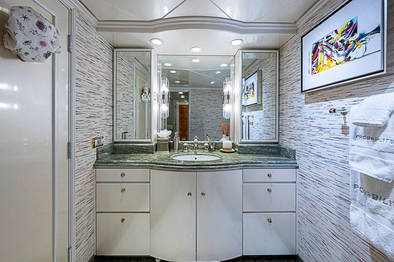 The bathroom features a sleek vanity with dual sinks and modern decor. aboard PROBABILITY Yacht for Sale