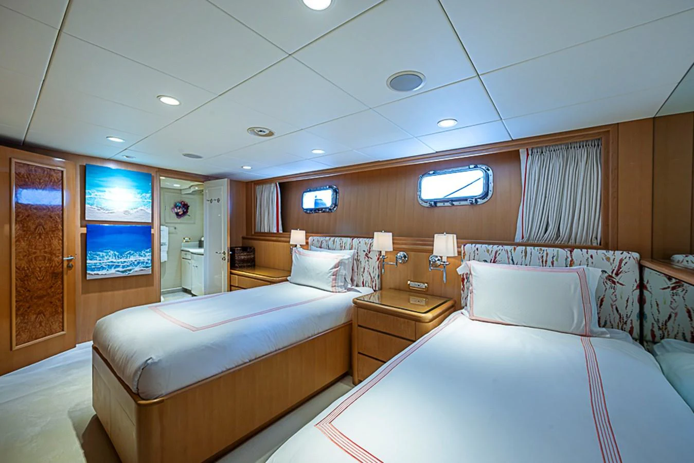 The twin stateroom offers a cozy and inviting space with two single beds and elegant decor. aboard PROBABILITY Yacht for Sale