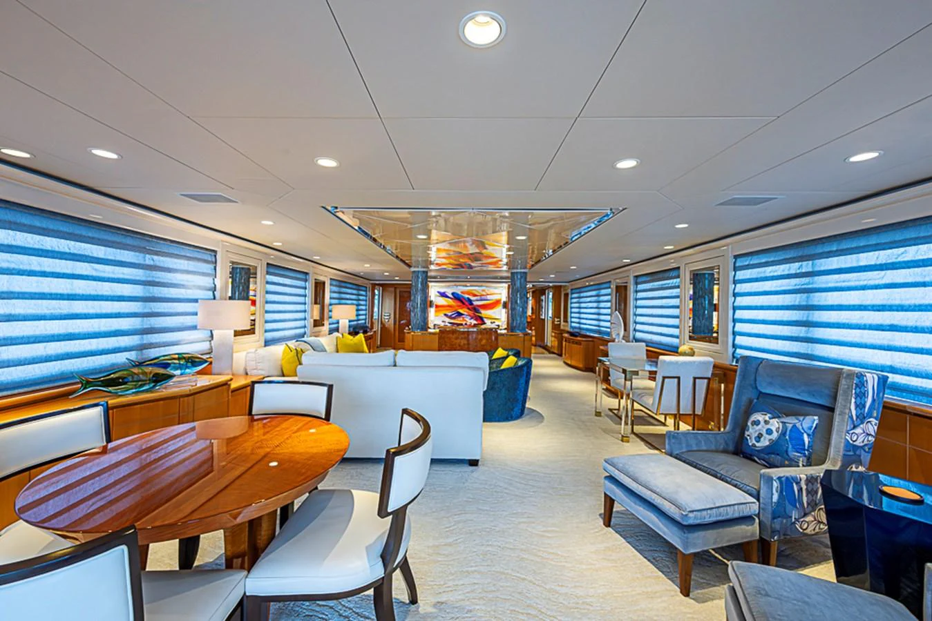 The yacht's salon is elegantly furnished with plush seating and a stylish dining area, creating a luxurious and inviting atmosphere. aboard PROBABILITY Yacht for Sale
