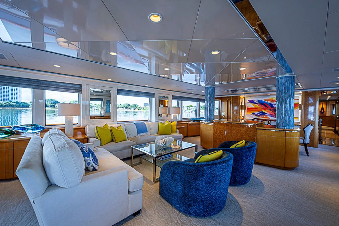 The yacht's interior features a spacious and elegantly decorated living area with plush seating and vibrant accents. aboard PROBABILITY Yacht for Sale