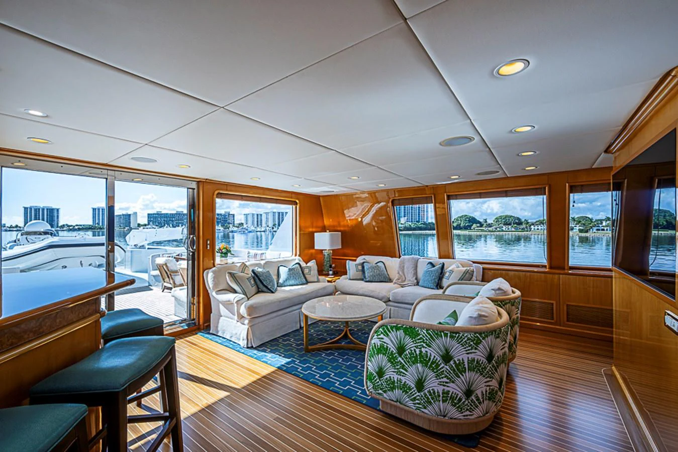 The salon offers a spacious and elegant seating area with panoramic views through large windows. aboard PROBABILITY Yacht for Sale
