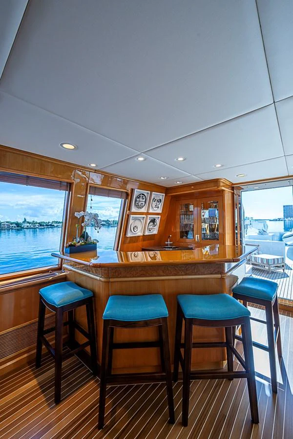 The yacht features a cozy bar area with a view of the water. aboard PROBABILITY Yacht for Sale