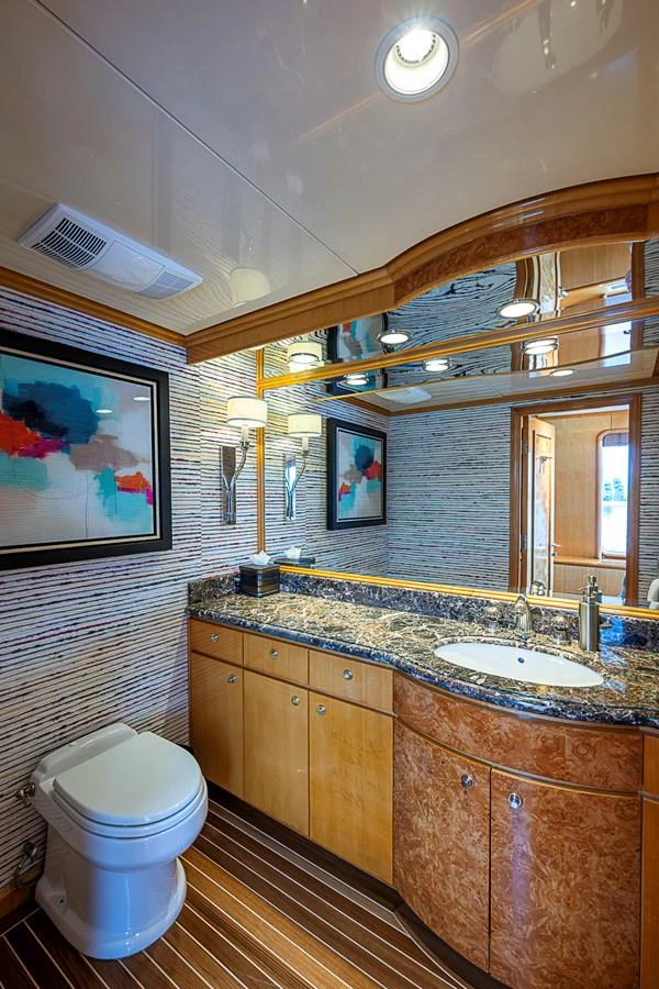 A luxurious yacht bathroom featuring elegant wood finishes and modern fixtures. aboard PROBABILITY Yacht for Sale