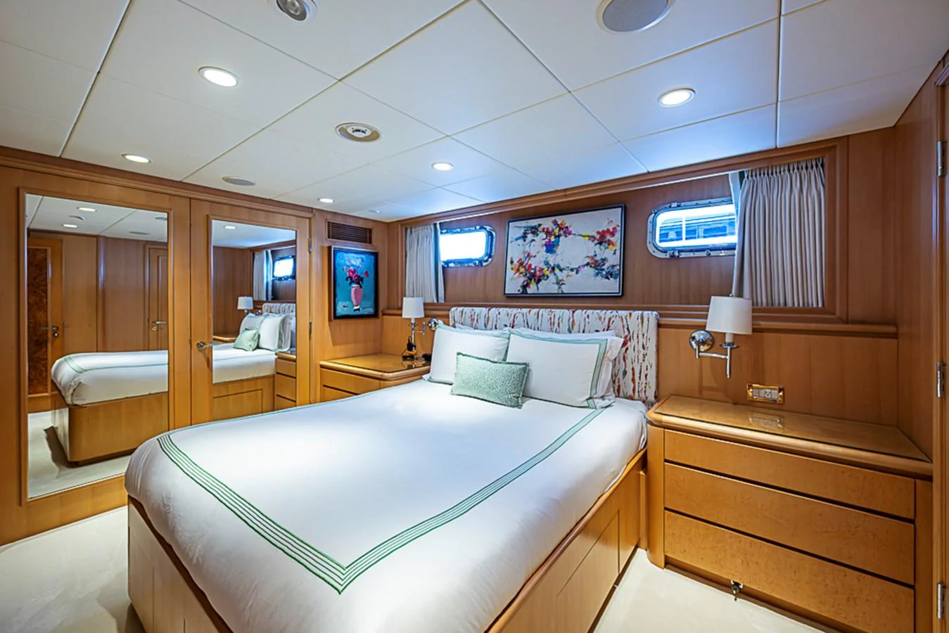 The stateroom features a cozy and elegant design with ample natural light and luxurious bedding. aboard PROBABILITY Yacht for Sale