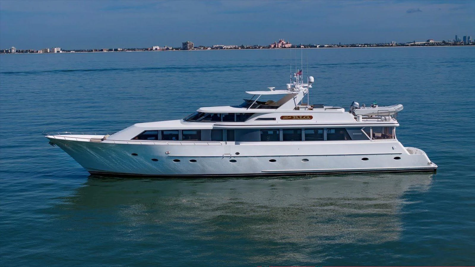 A sleek and elegant yacht cruises gracefully on calm waters, showcasing its luxurious design. aboard THINK B.I.G Yacht for Sale