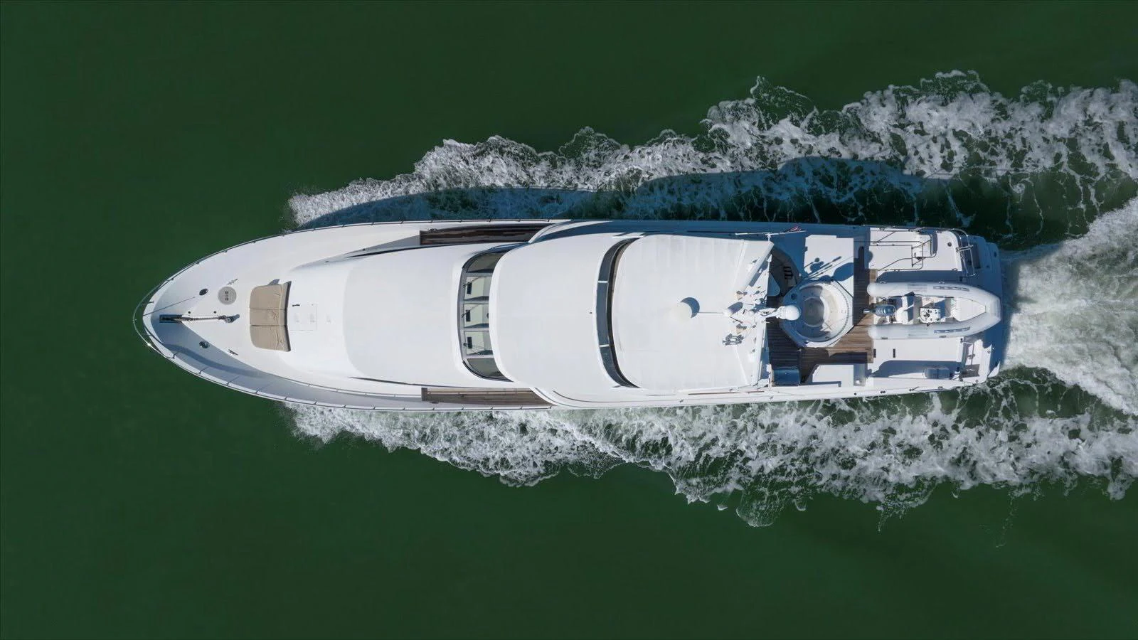 A sleek yacht glides smoothly through the water, showcasing its elegant design from an aerial perspective. aboard THINK B.I.G Yacht for Sale