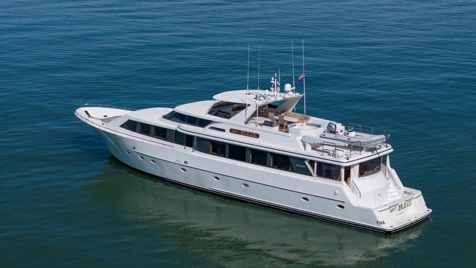 A sleek and elegant yacht glides gracefully on calm waters, showcasing its luxurious design. aboard THINK B.I.G Yacht for Sale