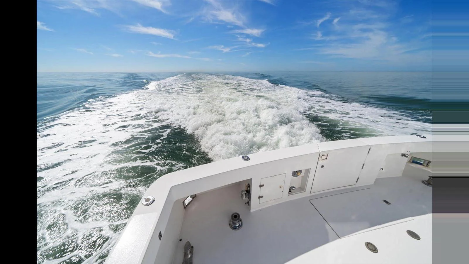 The yacht's aft deck offers a stunning view of the open sea and the wake left behind. aboard THINK B.I.G Yacht for Sale