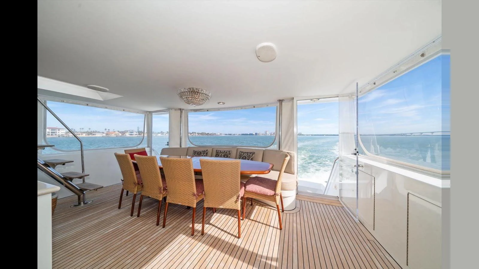 The yacht's dining area offers a spacious and elegant setting with panoramic views of the water. aboard THINK B.I.G Yacht for Sale