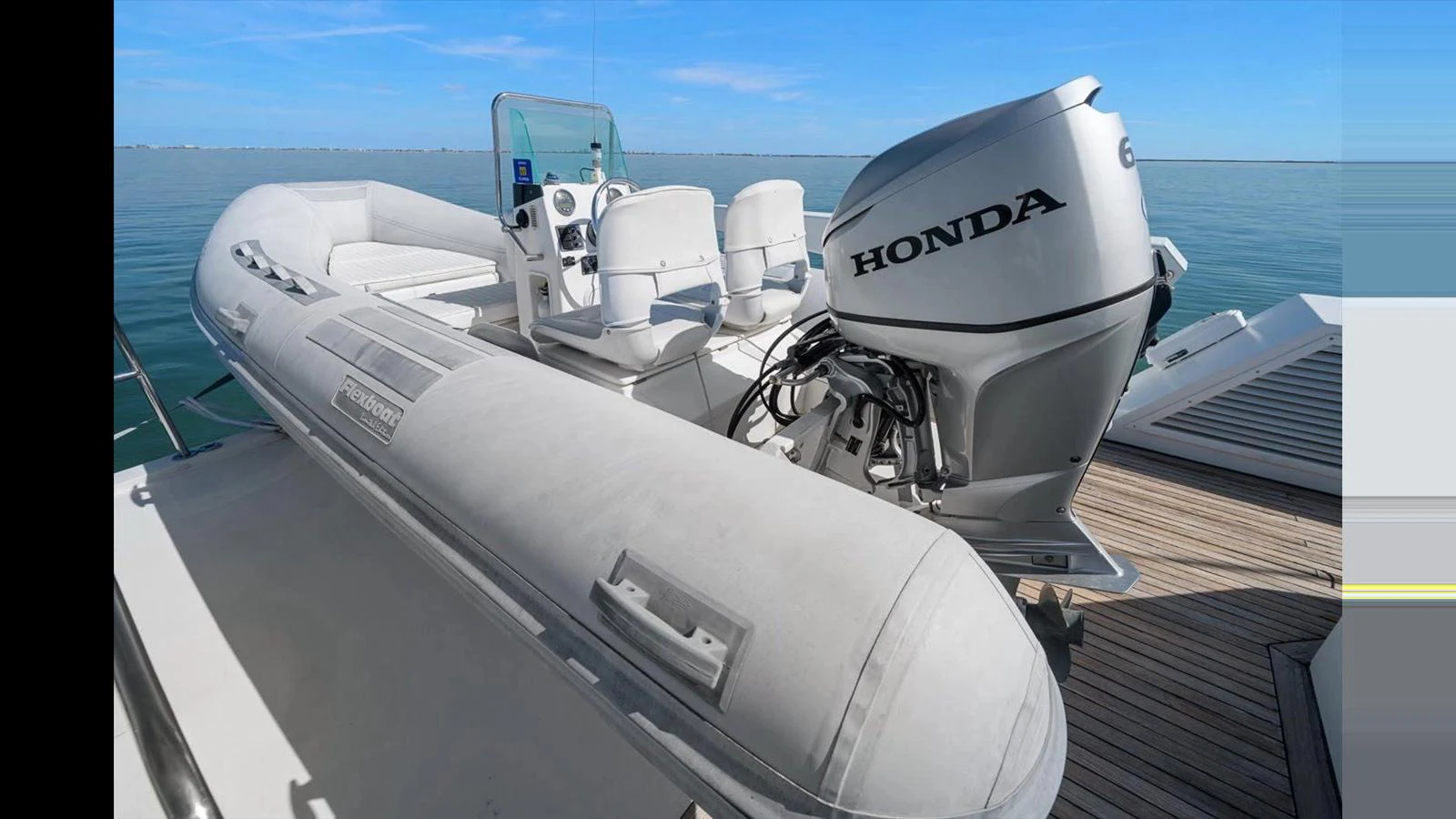 A sleek tender with a powerful Honda outboard motor is ready for adventure. aboard THINK B.I.G Yacht for Sale
