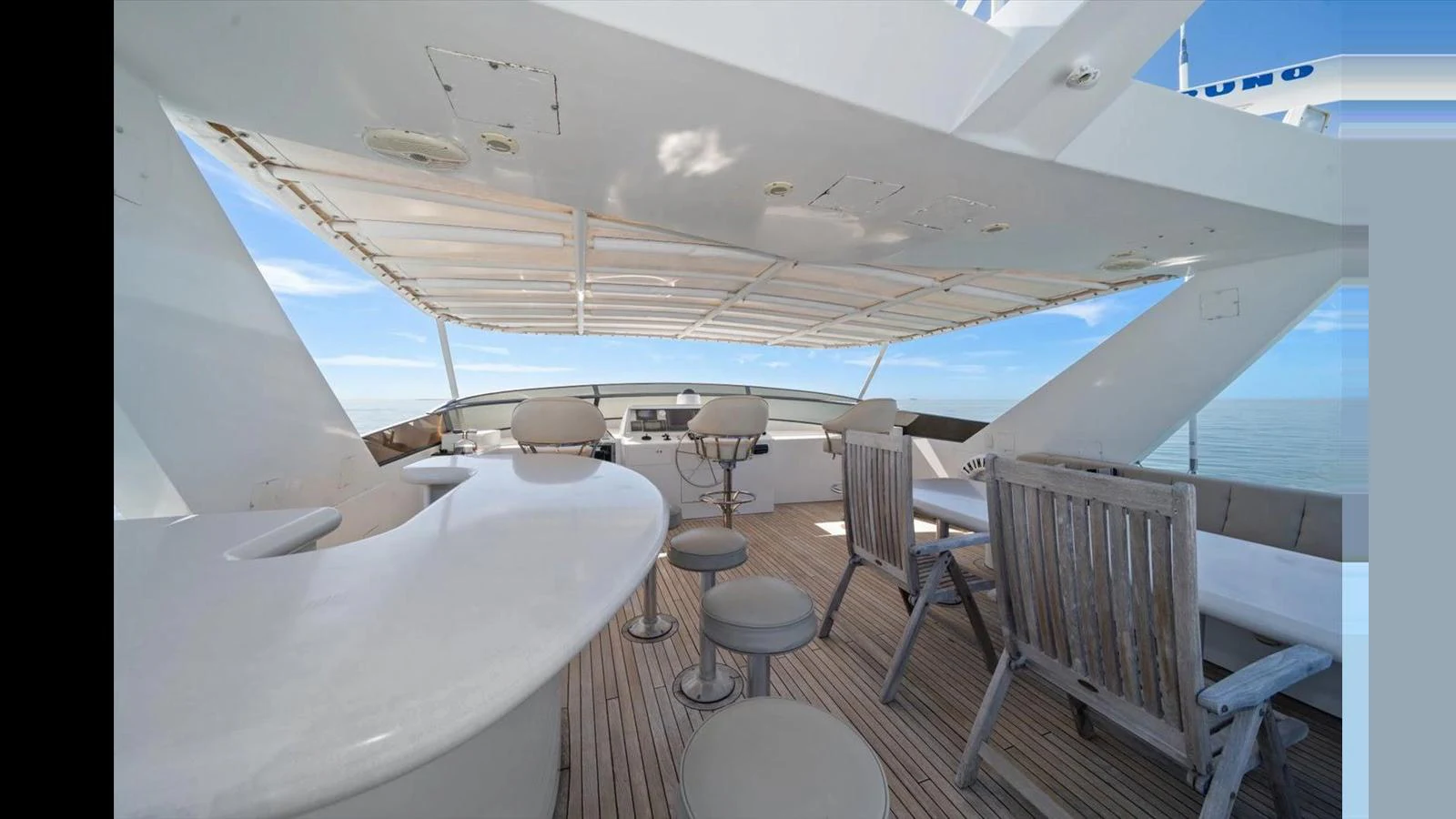 The flybridge offers a spacious and inviting area for relaxation and socializing with stunning ocean views. aboard THINK B.I.G Yacht for Sale