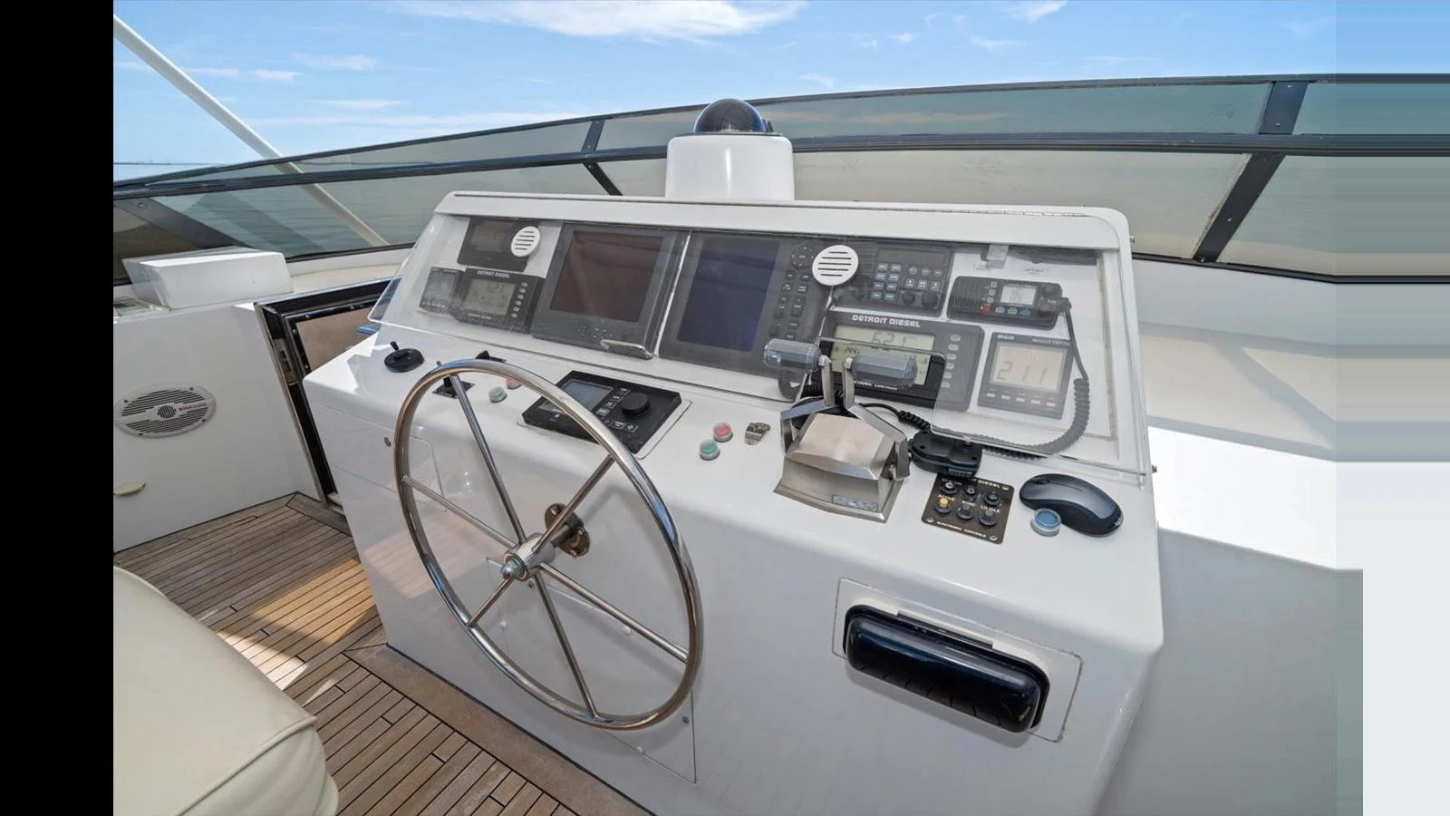 The helm station features advanced navigation equipment and a sleek steering wheel, offering a commanding view for the captain. aboard THINK B.I.G Yacht for Sale